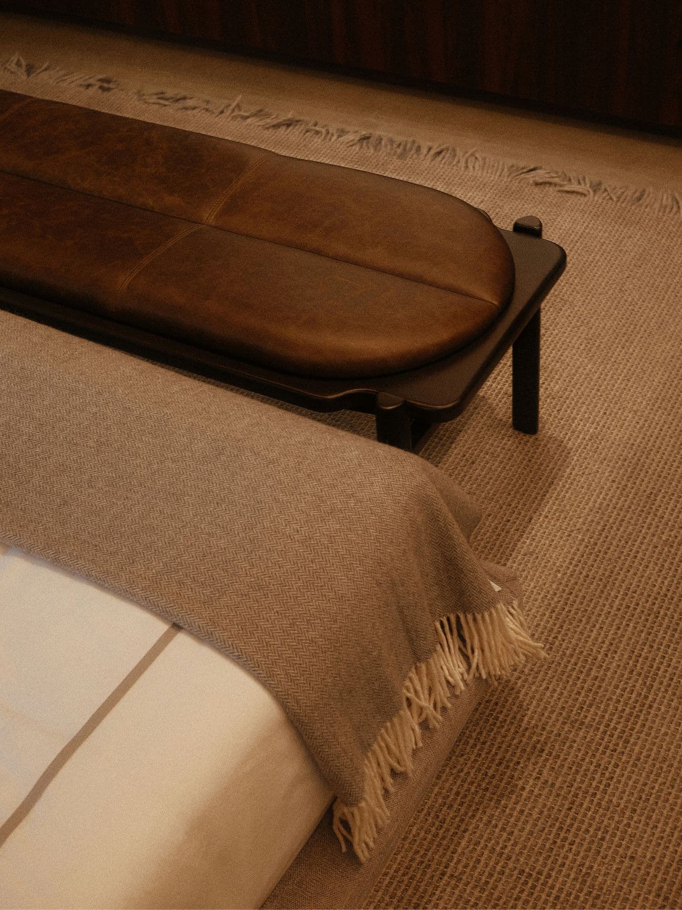 Woven blanket folded over the end of a hotel bed