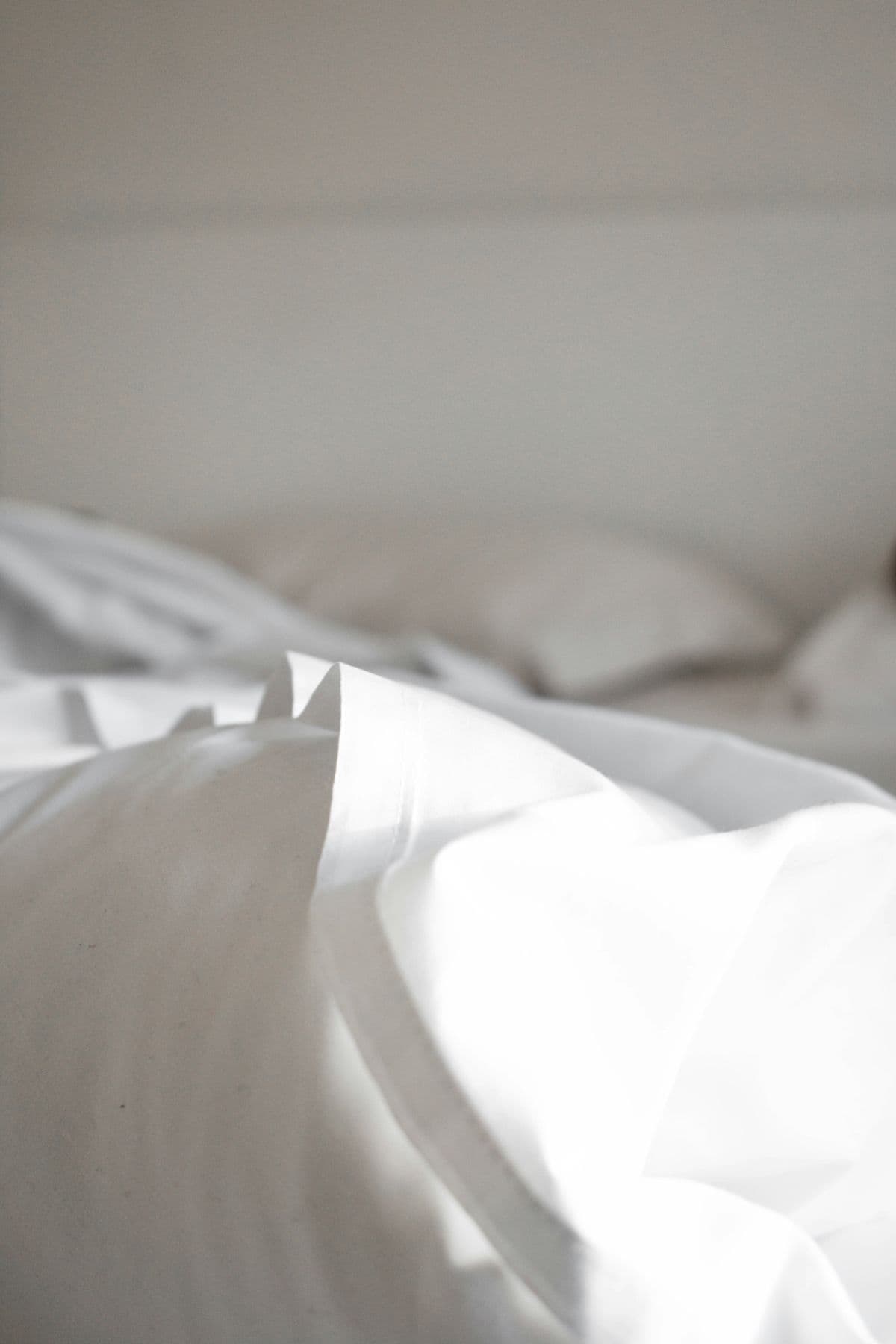 Hotel bed dressed with white linen